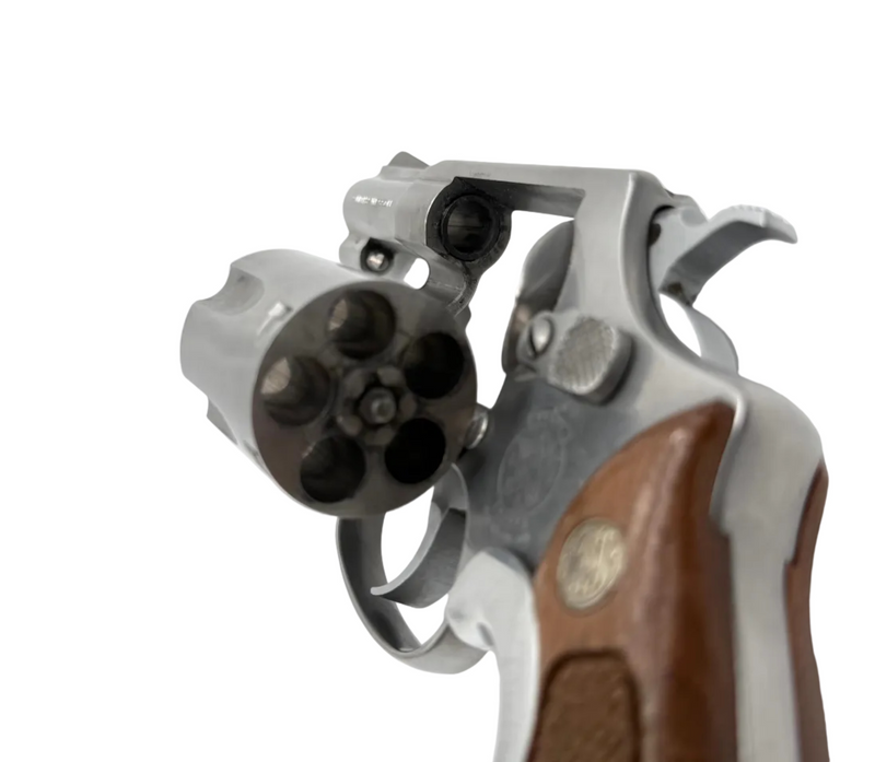 Close-up of a revolver with brown grip and silver metal on a white background