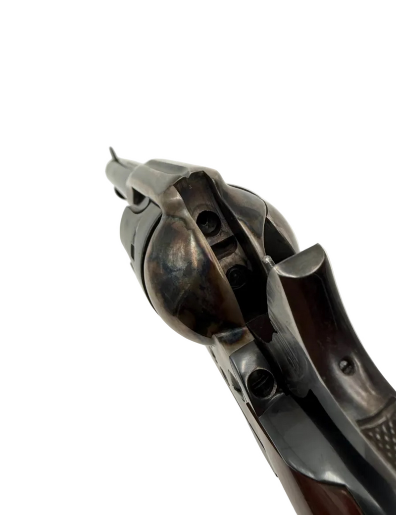 A. Uberti 1873 Cattleman .45 LC single action revolver with wooden grip and metal finish, displayed from a side angle.