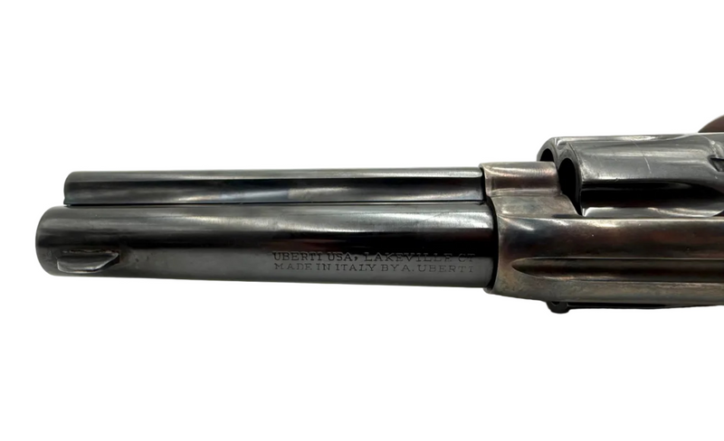 A. Uberti 1873 Cattleman .45 LC single action revolver with wood grip and metal barrel, displayed on a plain background.