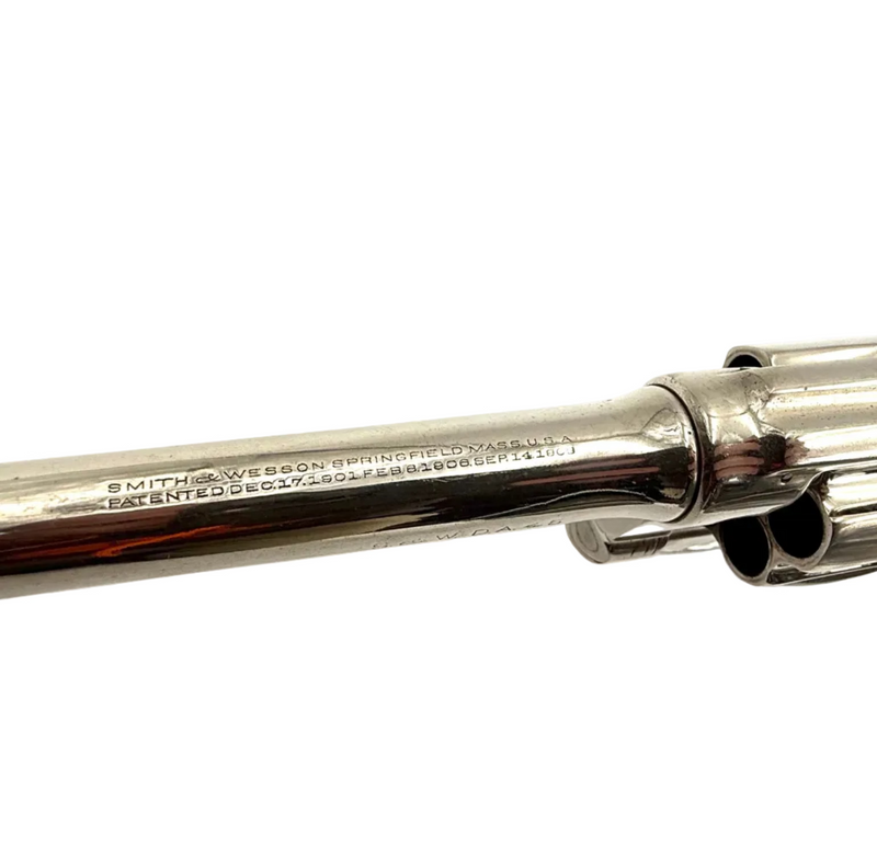 Close-up of a silver revolver on a white background