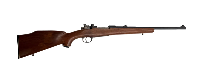 Fabrica De Armas La Coruna 1946 Spanish Mauser bolt action rifle with 7.92x57mm cartridge, shown in close-up.