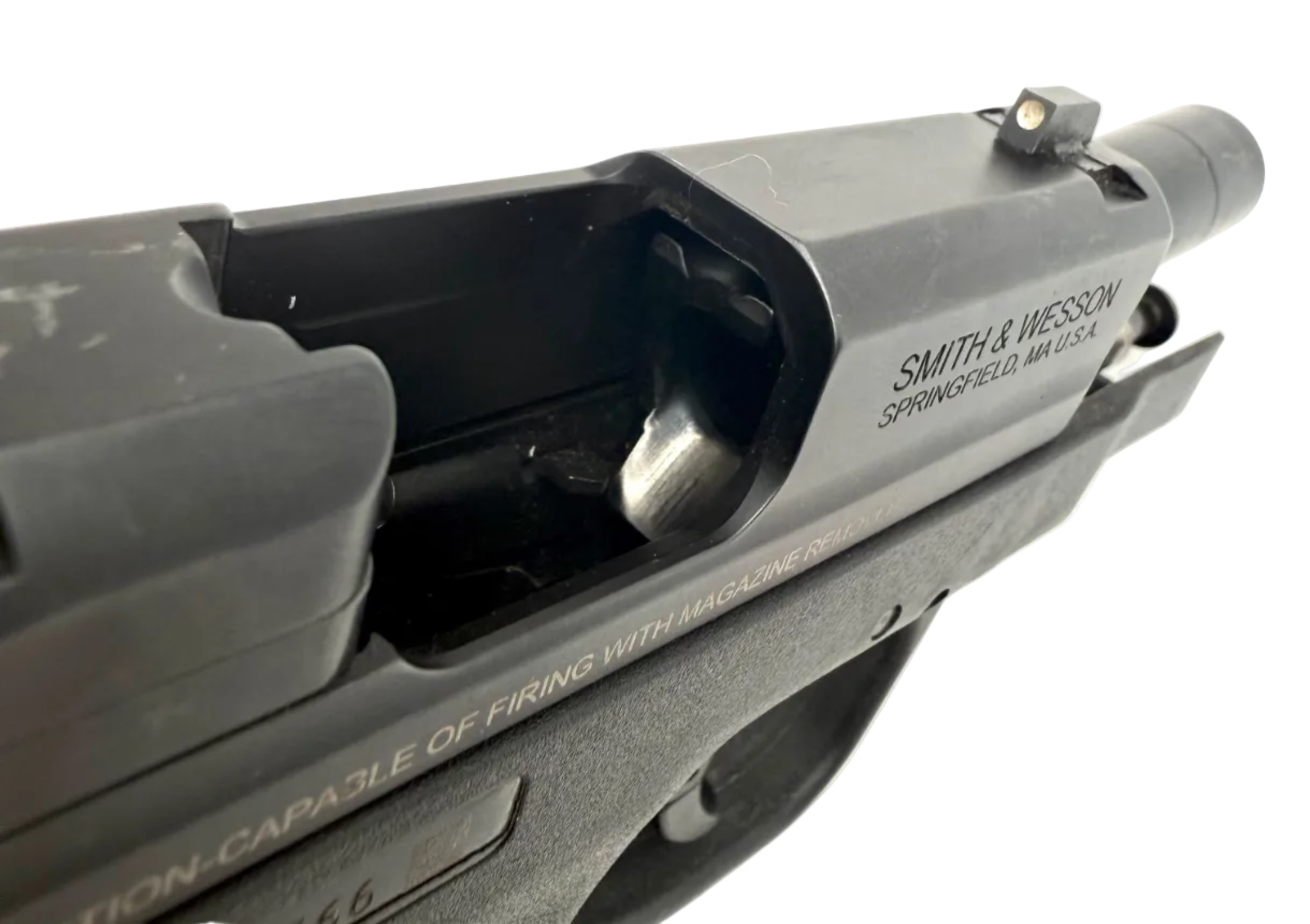 Smith & Wesson M&P 40 Shield semi-auto pistol with black polymer grip and stainless steel slide, shown from side view.