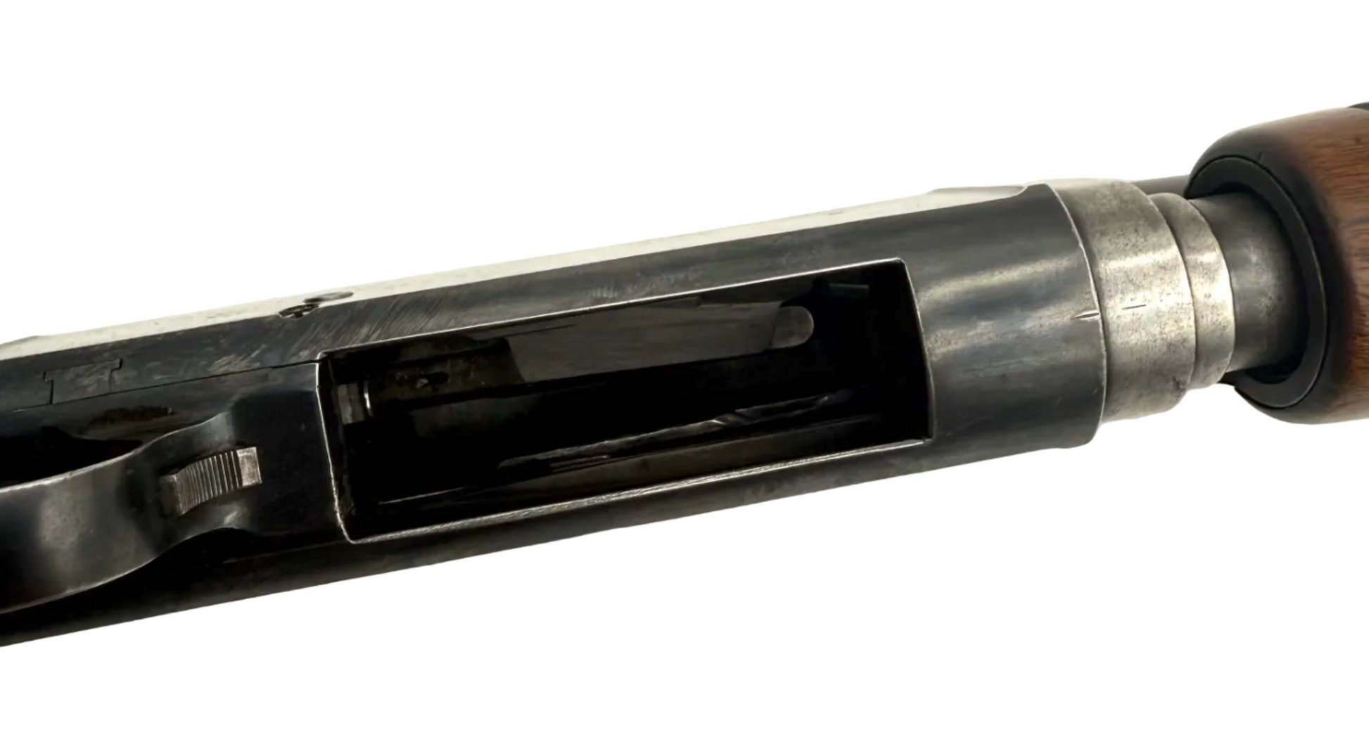 Remington Model 10 12 Gauge pump action shotgun with wooden stock and metal barrel, ready for hunting or shooting sports.