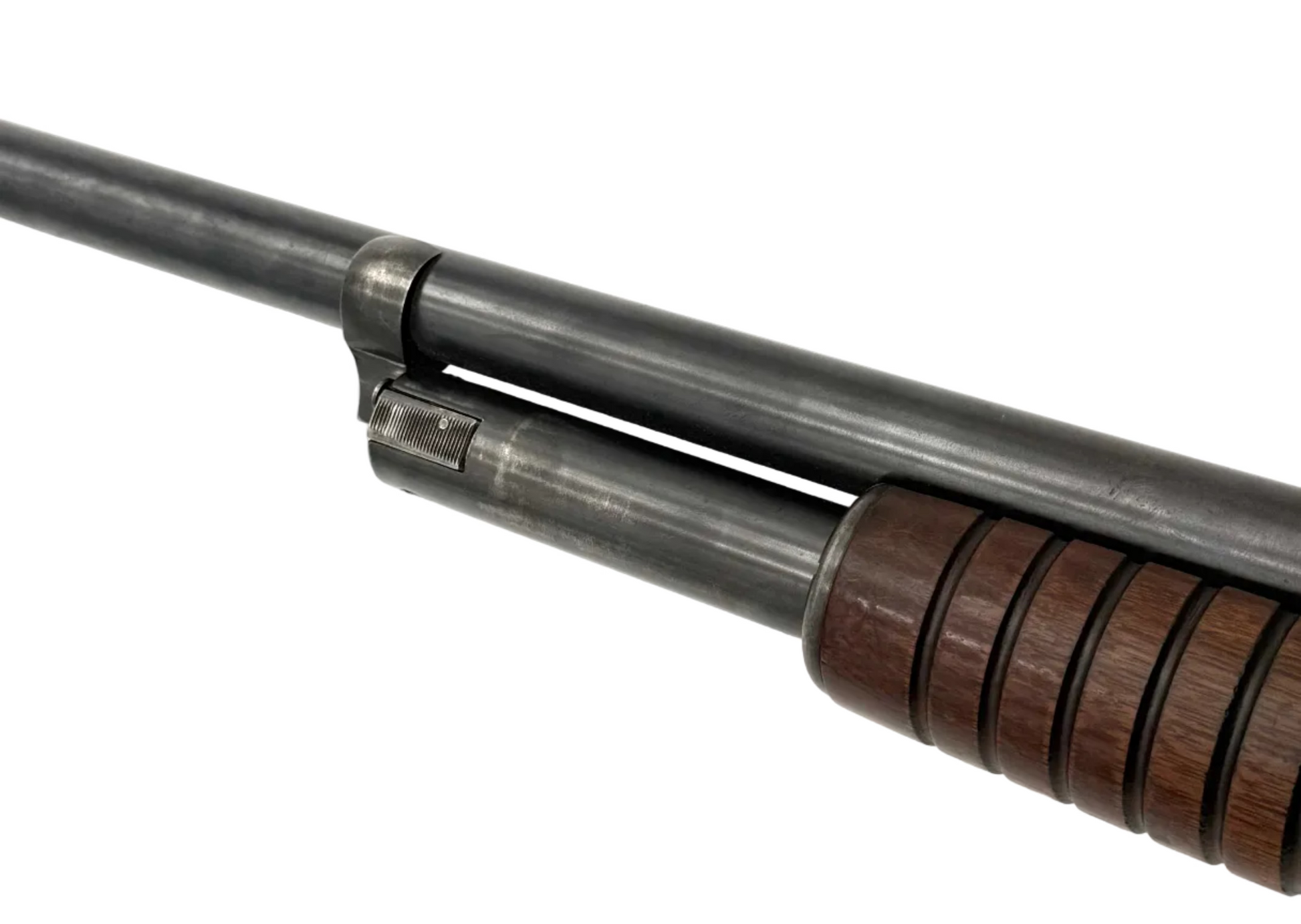 Remington Model 10 12 Gauge pump action shotgun with wooden stock and metal barrel, ready for hunting or shooting sports.