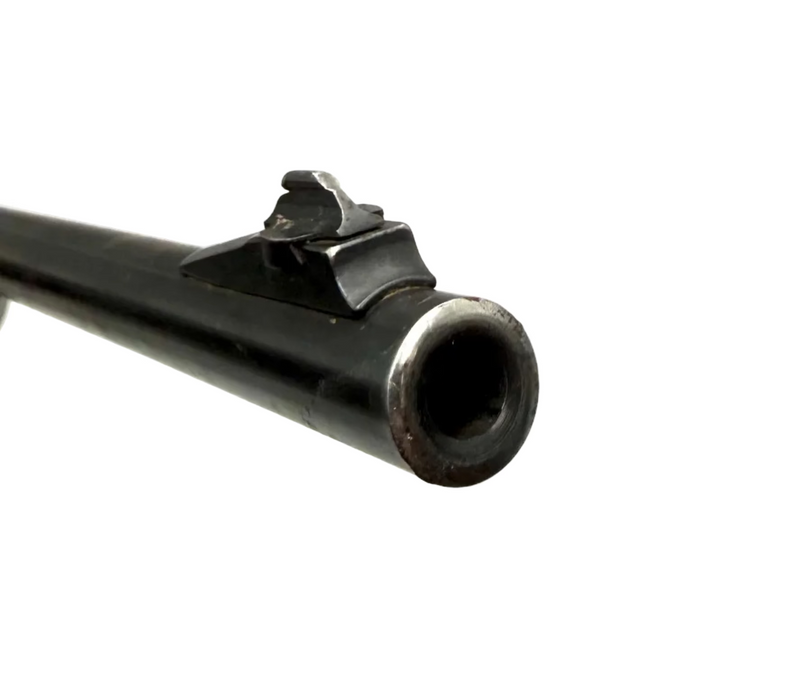Remington Model 740 .30-06 Springfield semi-auto rifle with wooden stock, mounted scope, and metal barrel.