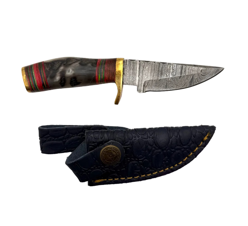 Close-up of a custom-made Damascus knife with a patterned blade and ergonomic handle, showcasing craftsmanship and unique design.