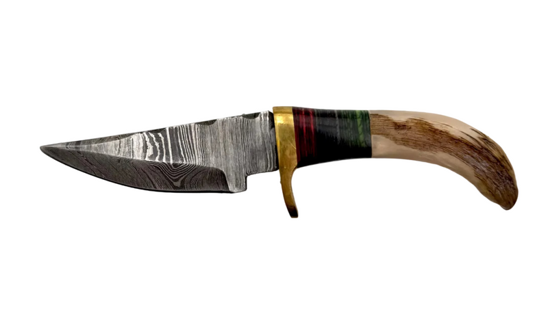 Close-up of a custom-made Damascus knife with a patterned blade and wooden handle, highlighting craftsmanship and intricate design.