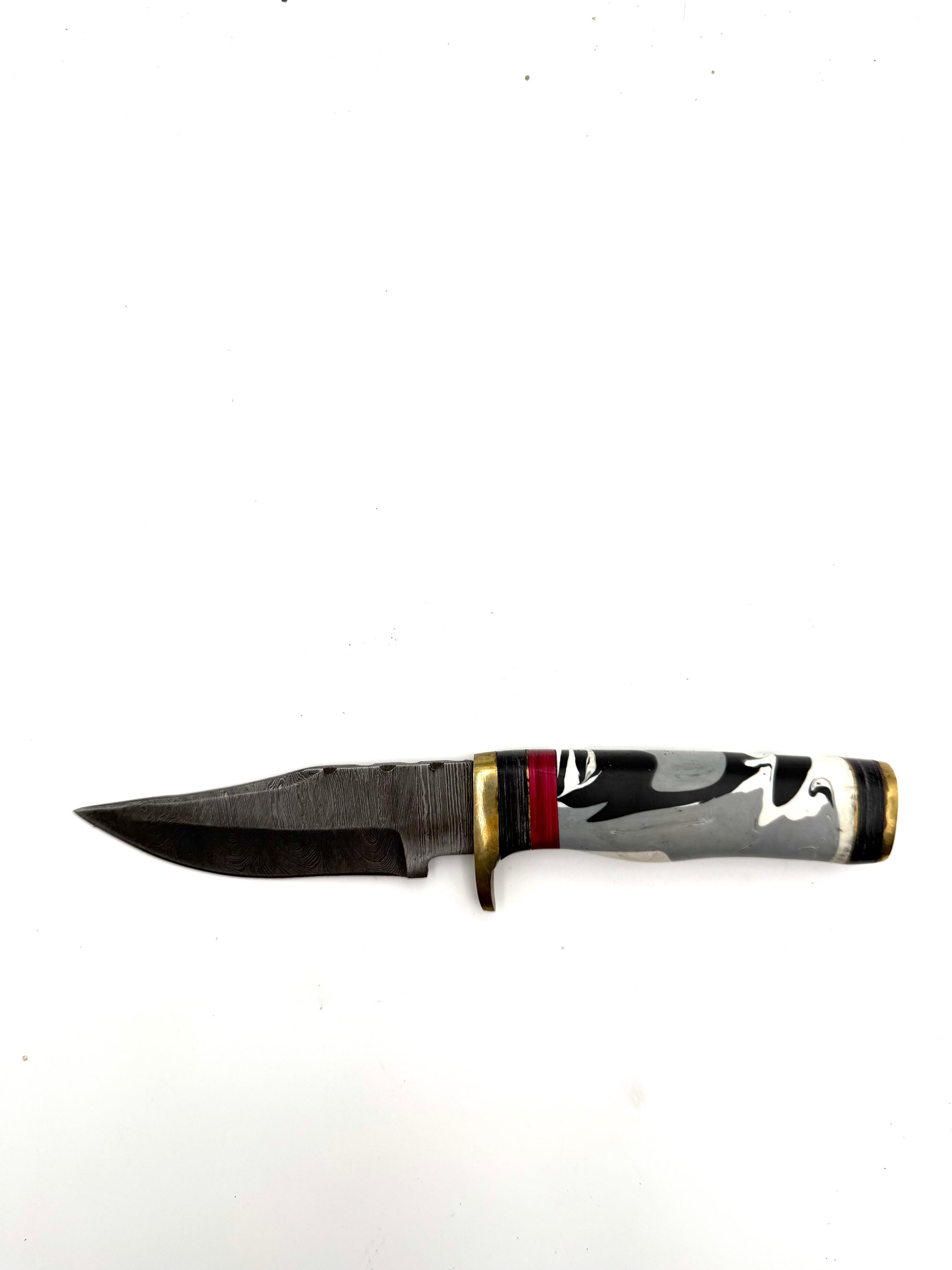 Close-up of a custom made Damascus knife showing its intricate patterned blade and polished wooden handle.
