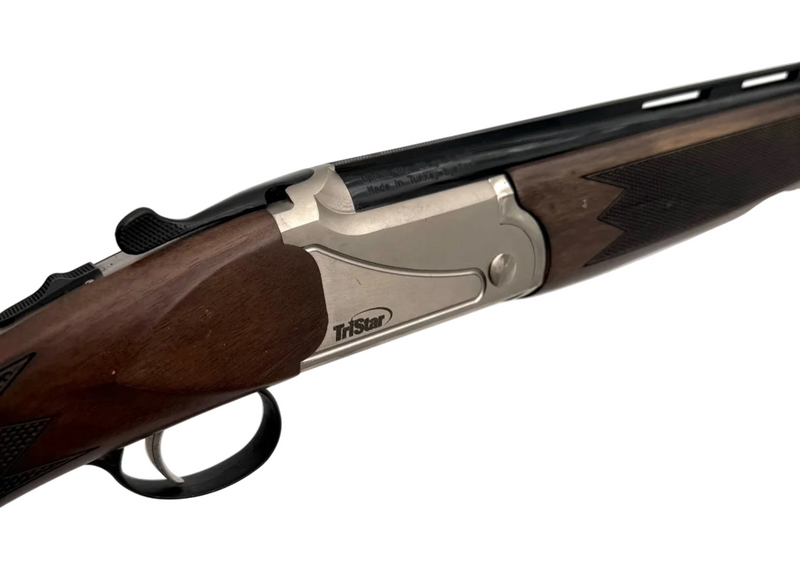 TriStar Upland Hunter 20 Gauge over-under shotgun with wooden stock and metal barrel, displayed in a natural outdoor setting.