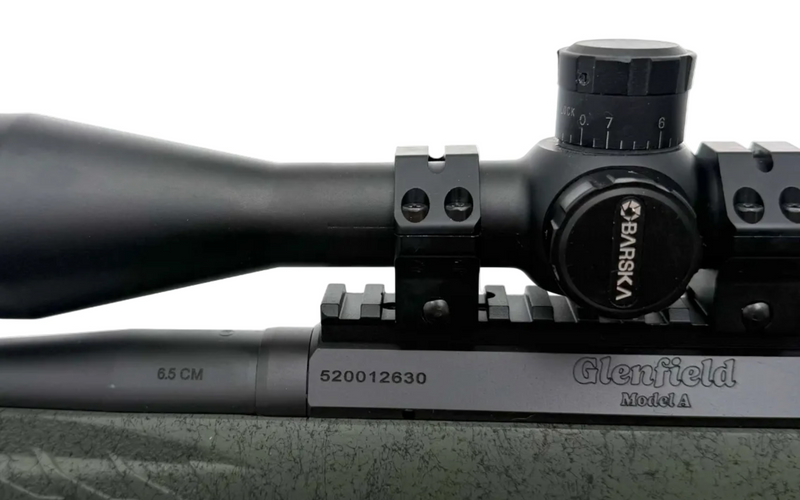 Glenfield Model A bolt action rifle with 6.5 Creedmoor caliber and wooden stock, shown from a side view.